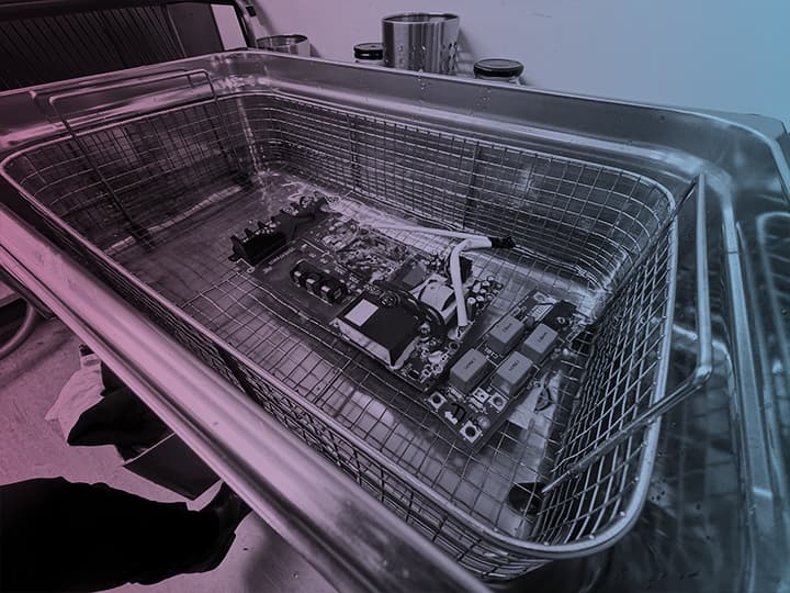 Circuit board being cleaned in a workshop bath