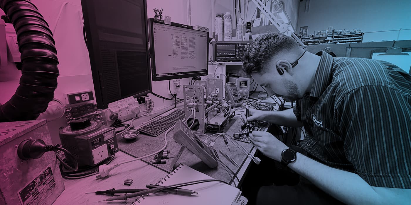 Precision Electronics technician diagnosing an industrial circuit board
