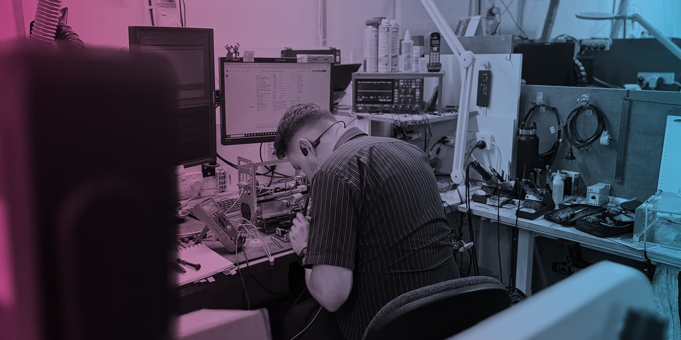 Precision Electronics technician working at an electronics test bench